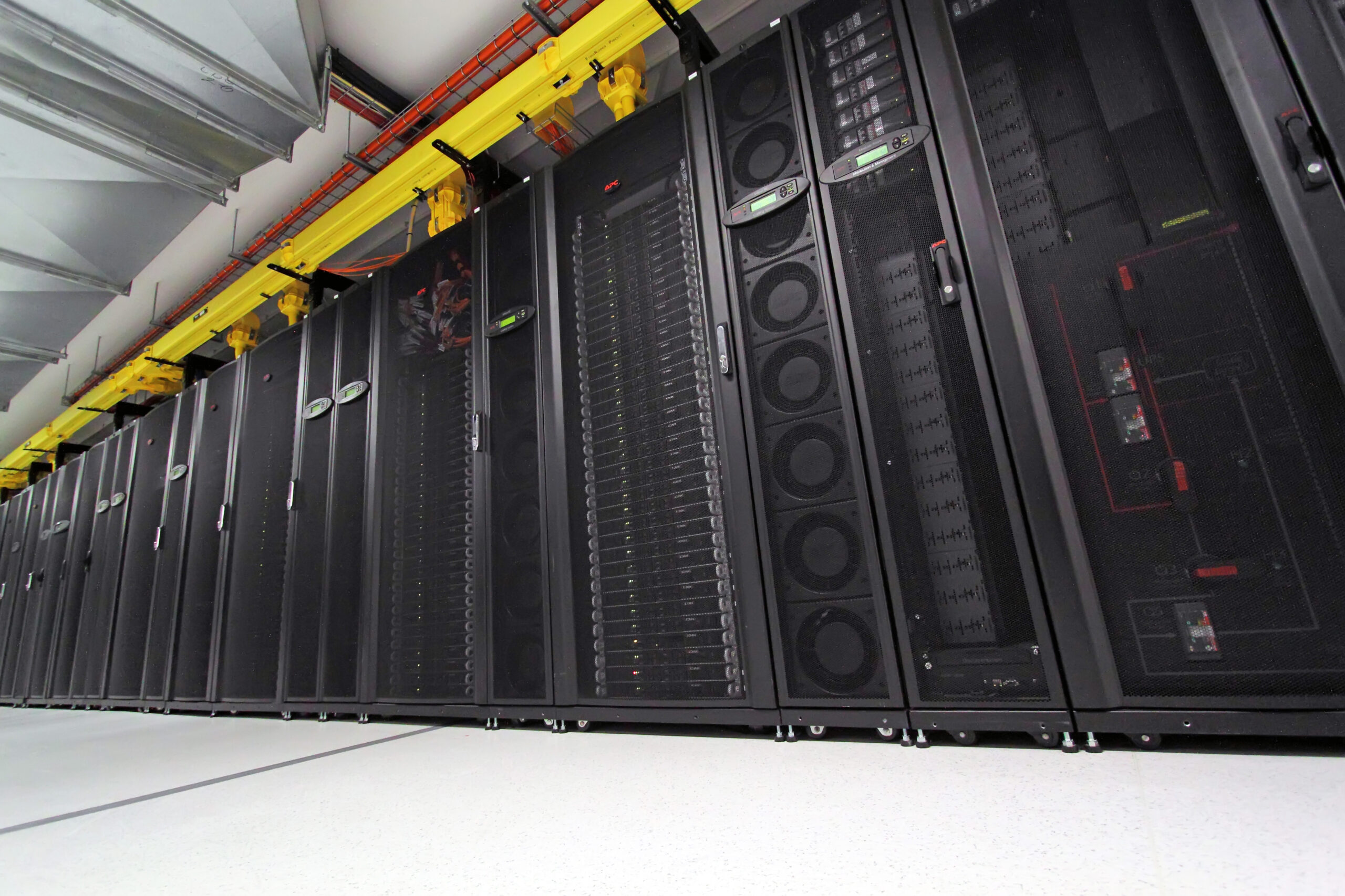 Computer servers housed in a row of equipment racks.