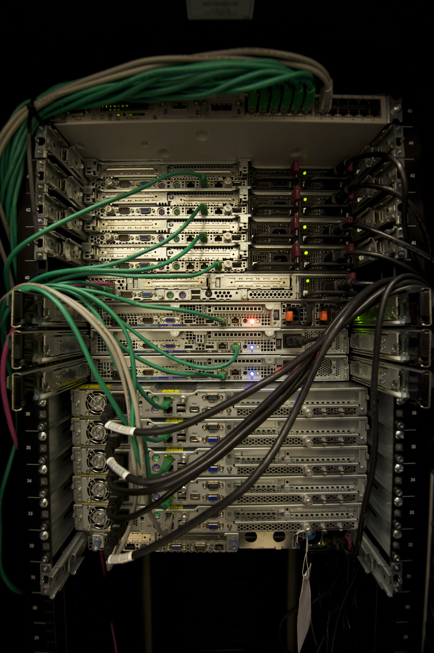 Rack-mounted server equipment with connected network and power cables.